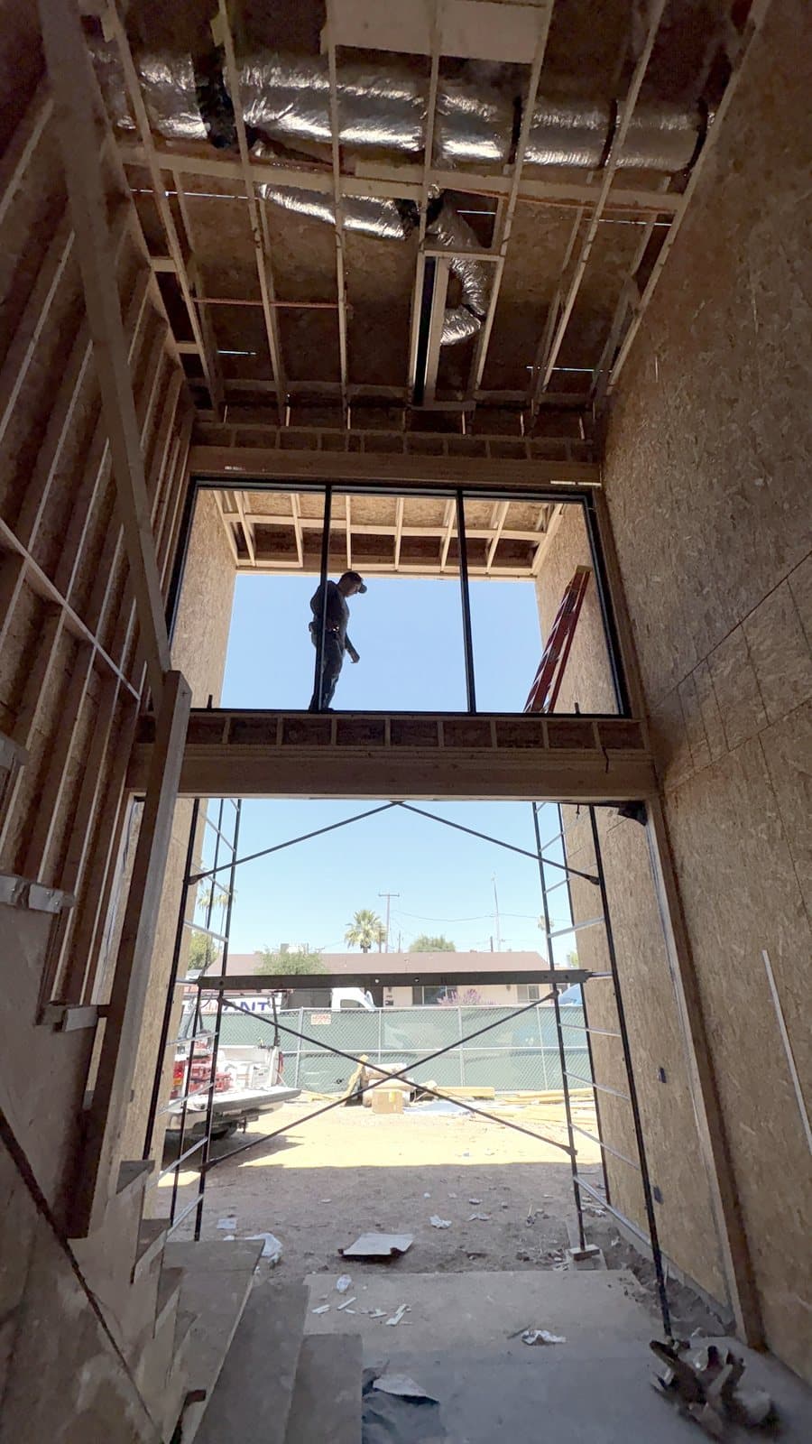 Tall new opening framed into an existing wall, mid-construction