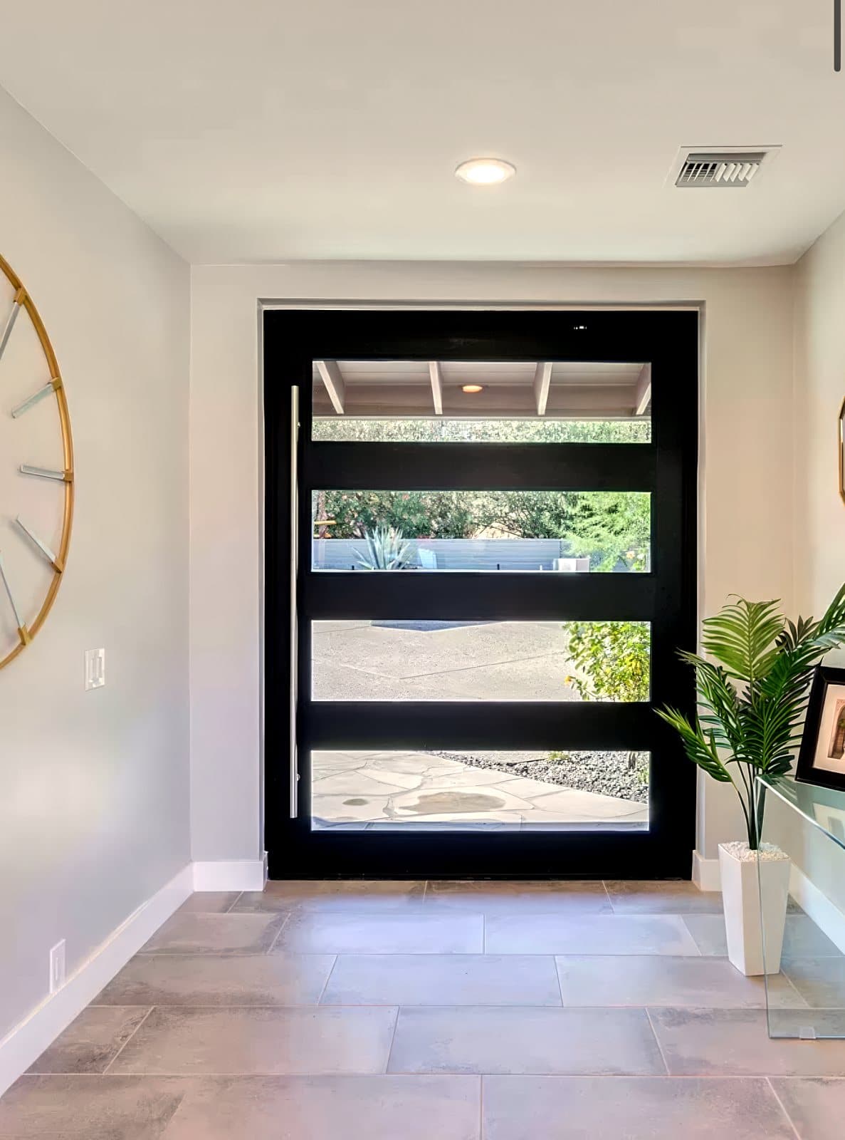 Modern glass-lite entry door seen from inside the foyer